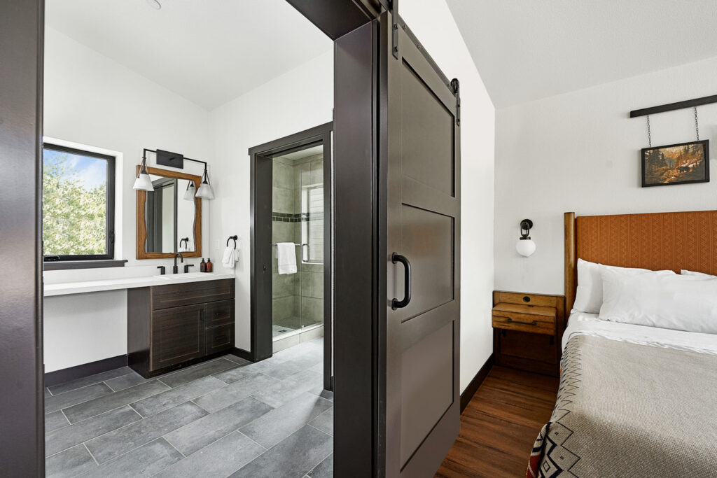 Photo captures the interior of an attached bathroom from the bedroom perspective.
