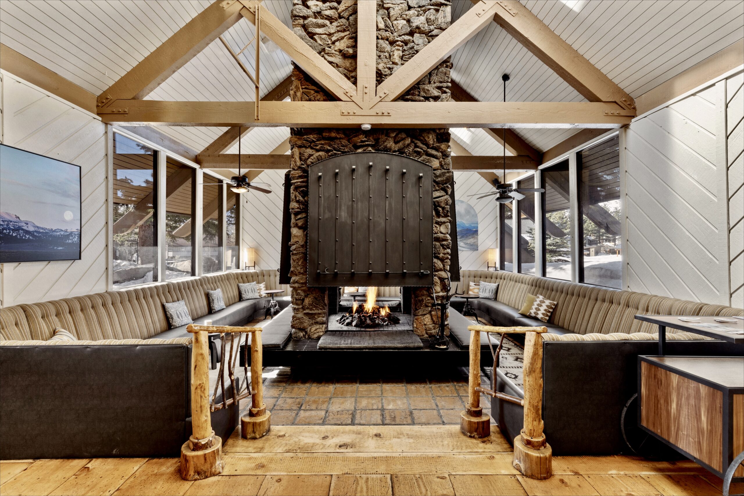 Cozy seating area perfectly arranged beside the warm fireplace for a comfortable ambiance.