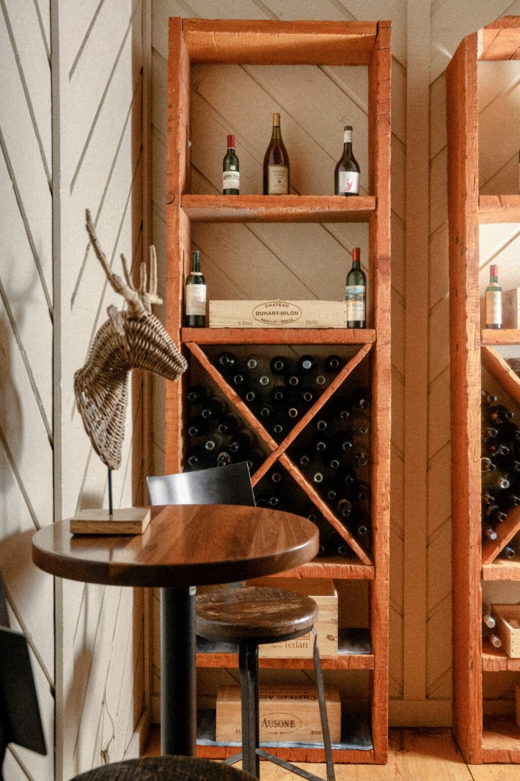 Designer cupboard embellished with various types of wine bottles.