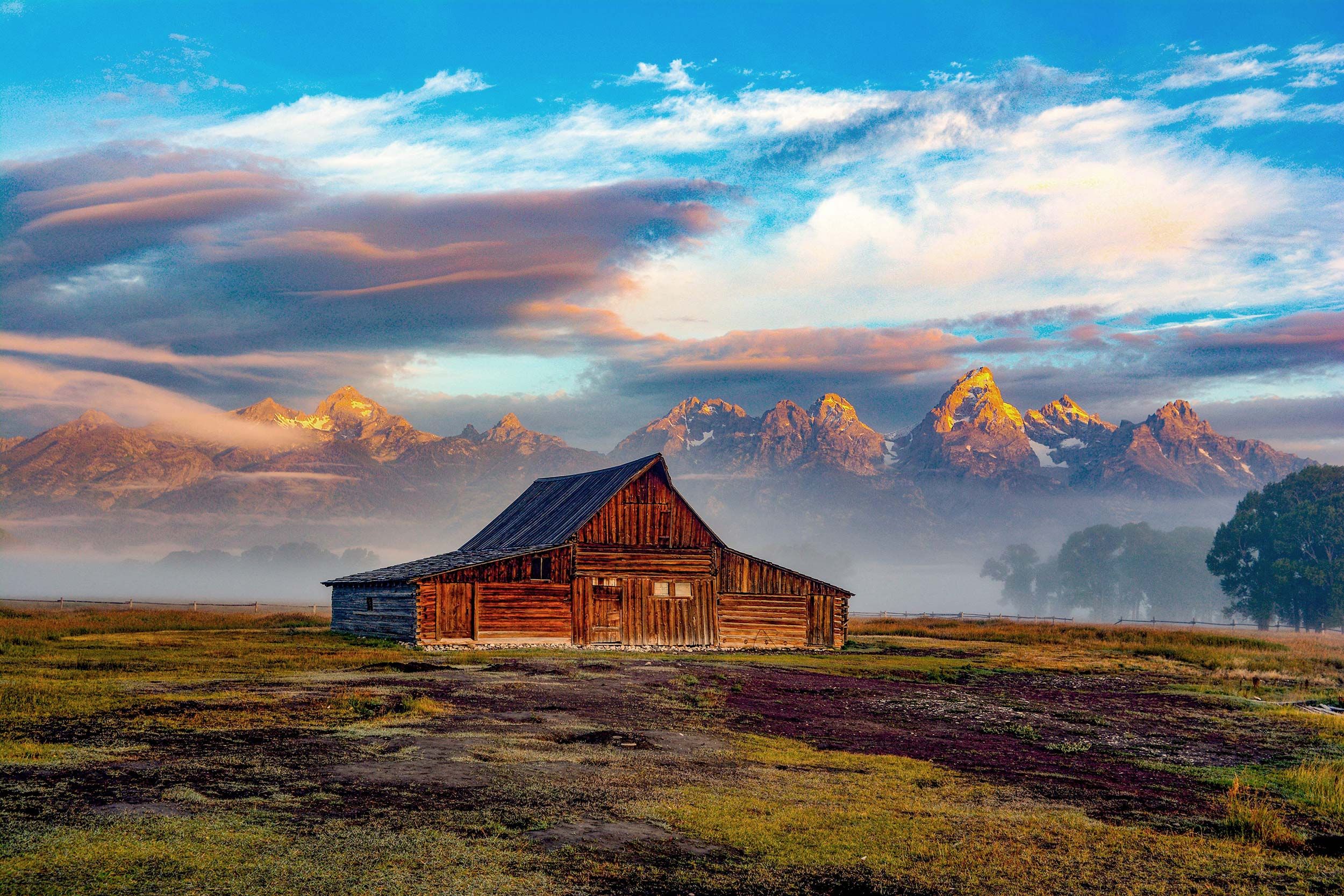 A stunning photograph capturing a house against the backdrop of a scenic mountain edge.