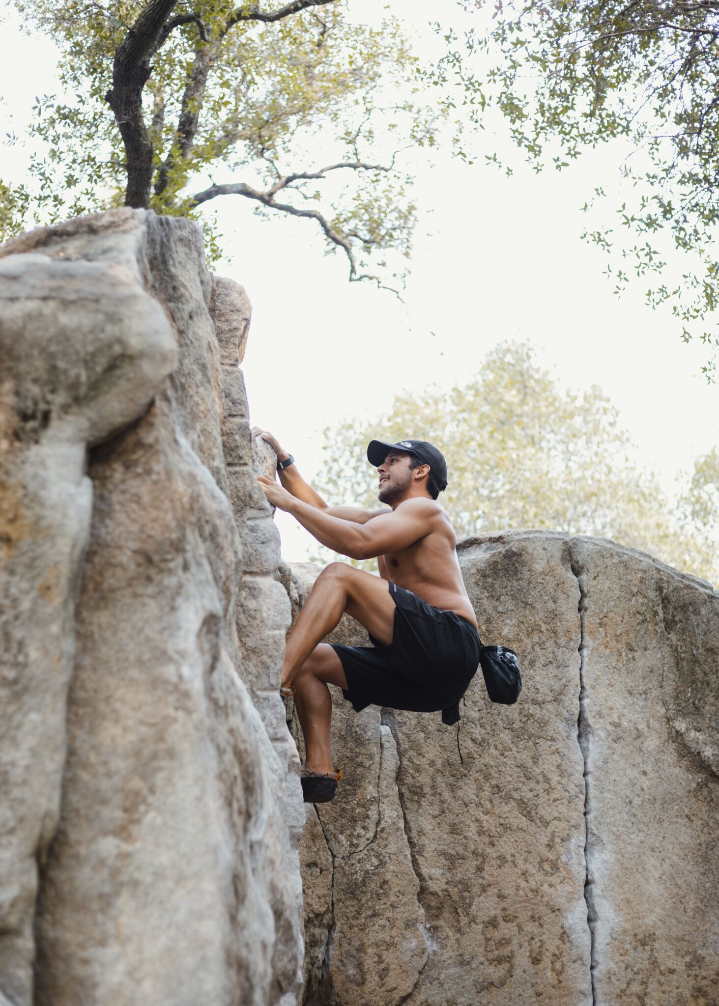 A man engages in the activity of rock climbing, displaying strength and determination.