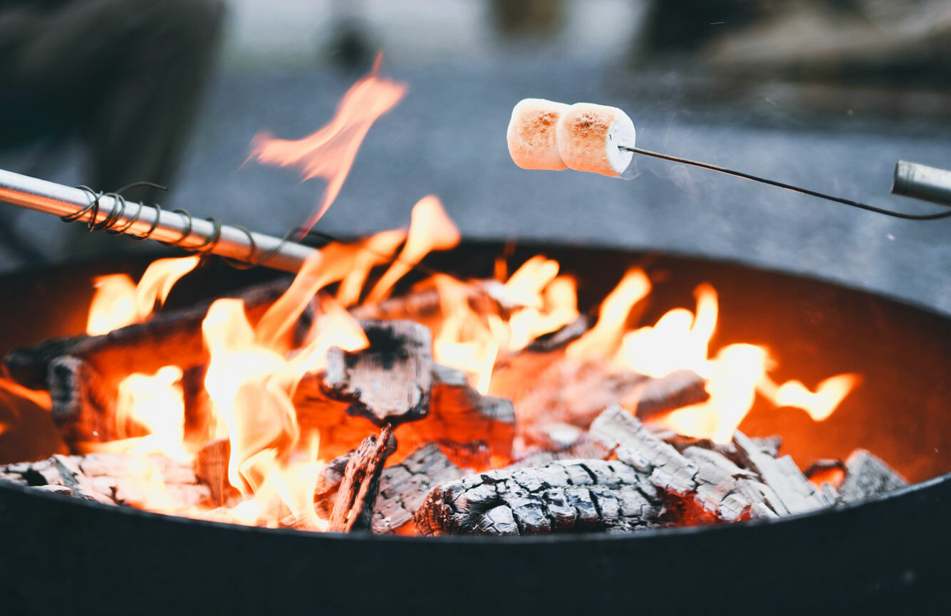 Marshmallows sizzle over the fire, creating a cozy and delightful vacation atmosphere.
