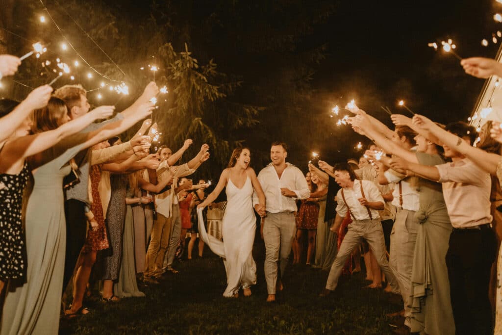 Outbound Mammoth - Weddings - Bride and Groom Walking Through Sparklers