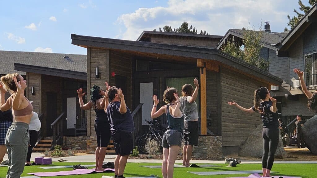 Guests practice yoga on the lawn at our boutique hotel in Mammoth Lakes