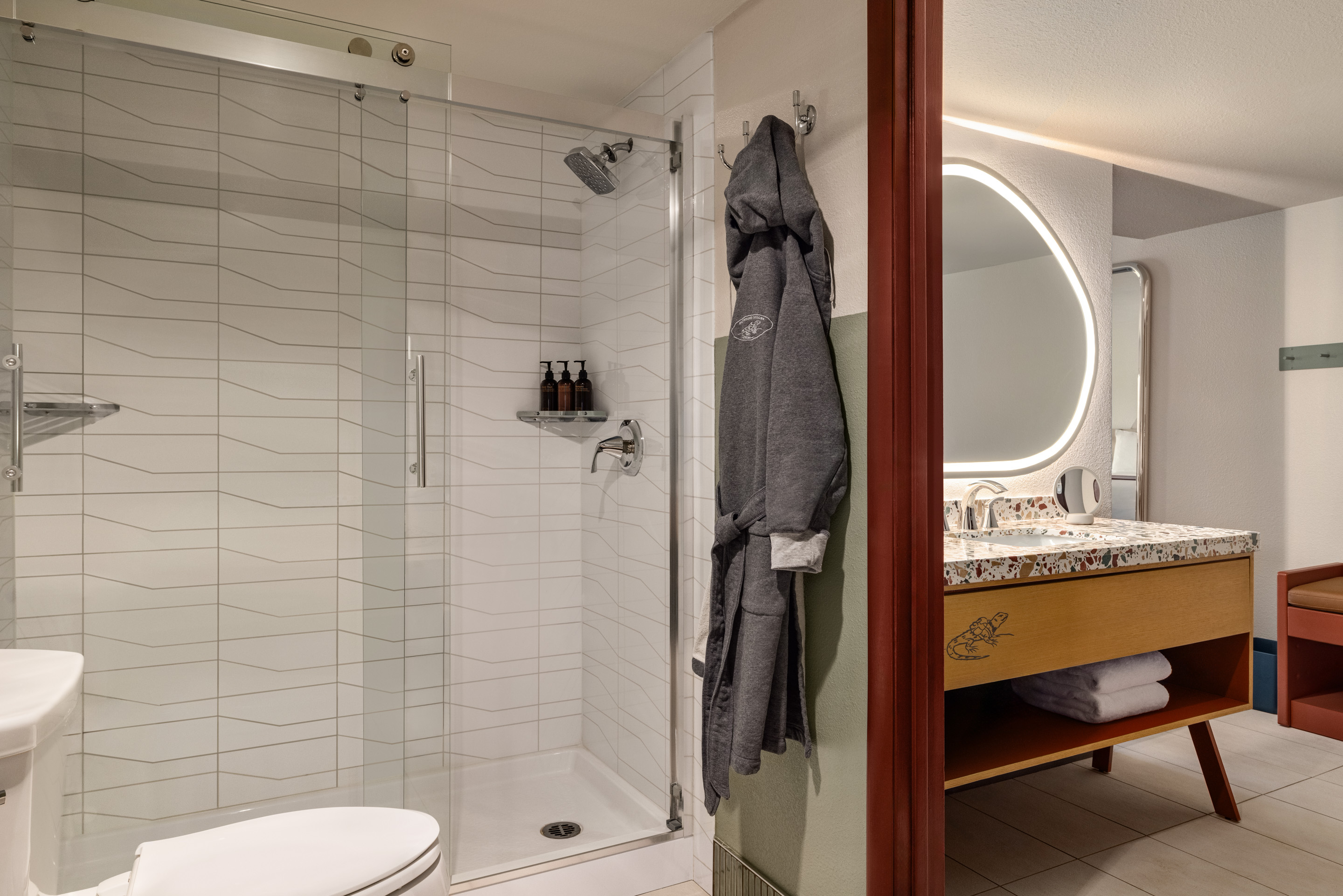 A bathroom with a shower, toilet, and sink