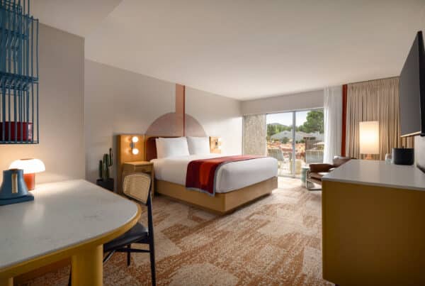Pool Patio King room at Outbound Sedona with a king bed and private patio overlooking the pool and red rock views