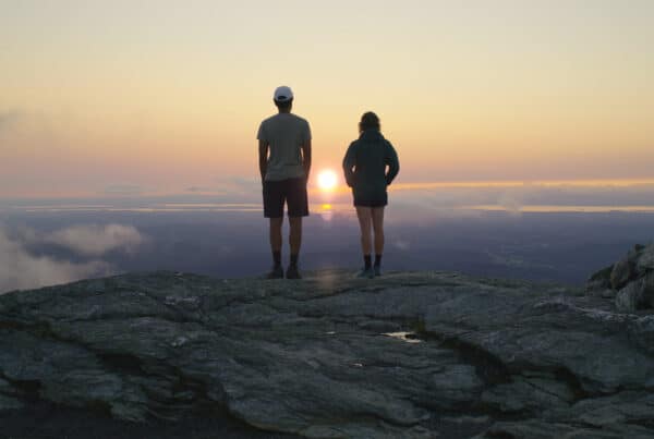 two hikers on a mountain overlook in Stowe Vermont