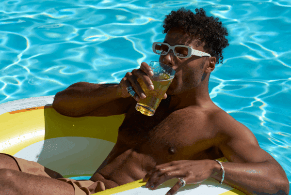 man in pool with drink at outbound stowe