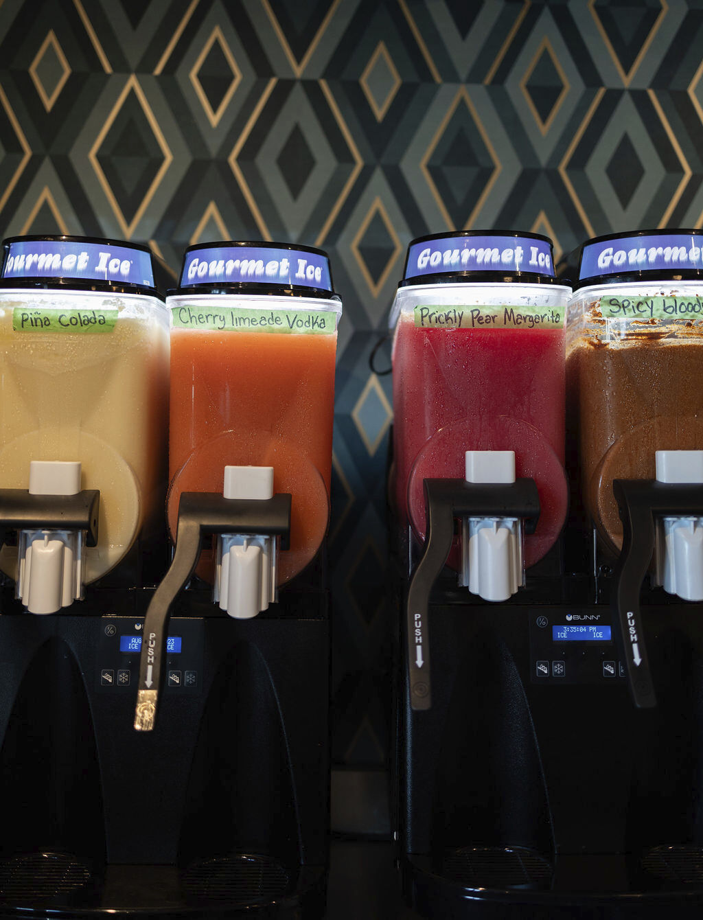 Photo captures four juice jars with taps, providing customer convenience in an appealing display.