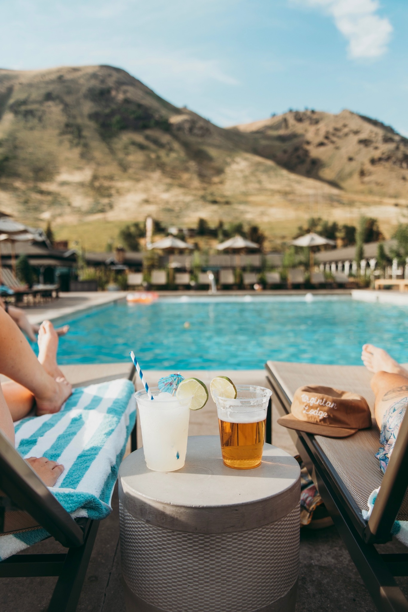 Lounge chairs by the pool provide a perfect vantage for admiring the lush green mountain.