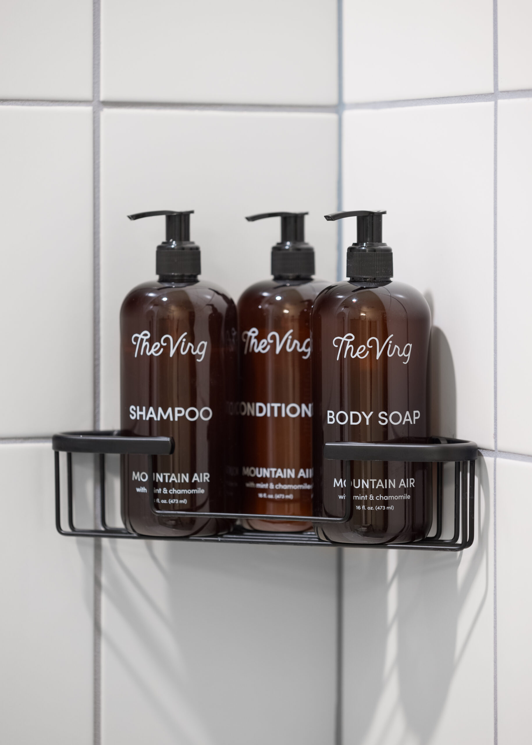 Organized arrangement on the rack with three neatly placed soap dispenser bottles.