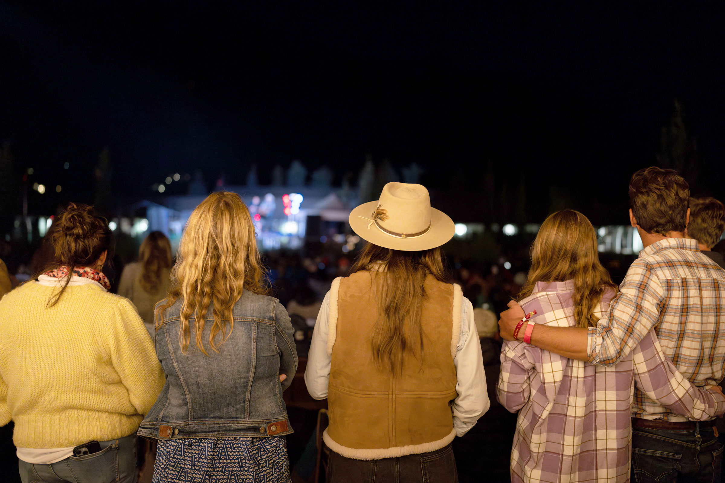 People revel in the night music concert in the open ground, embracing the lively atmosphere.