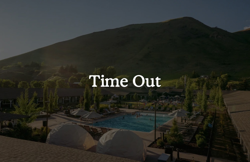 Pool and hotel exterior with “Time Out” text overlay.