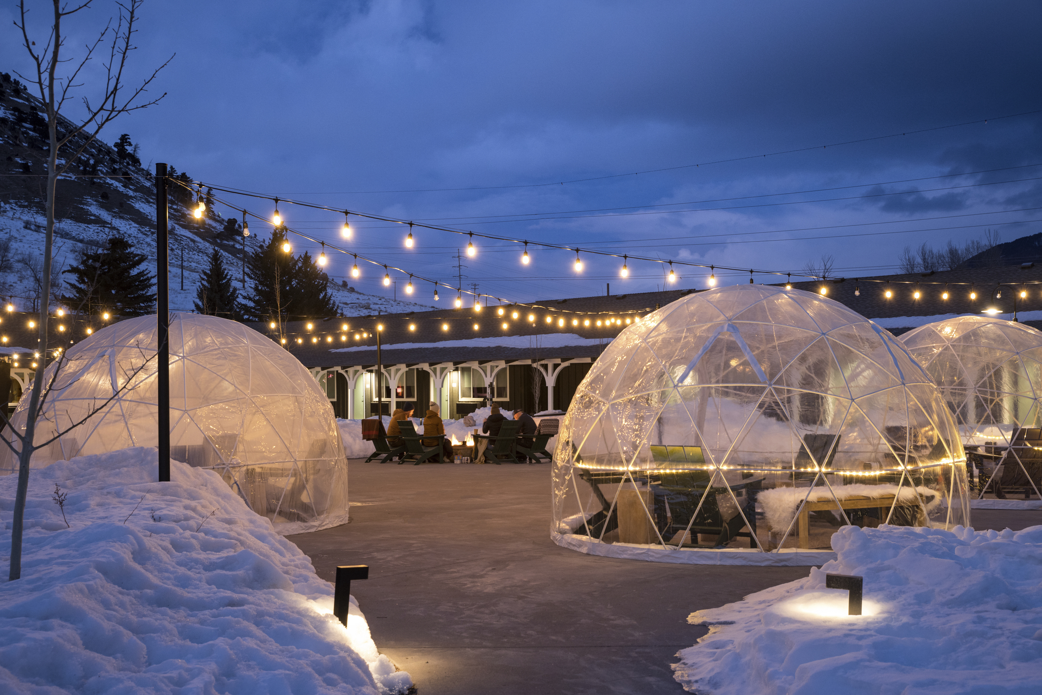 Unique igloo-inspired outdoor dining area with exceptional lighting creates an impressive atmosphere.